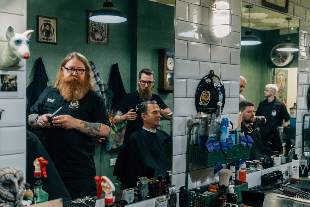 A lineup of barbers in The Dandy Gent as they service their clients