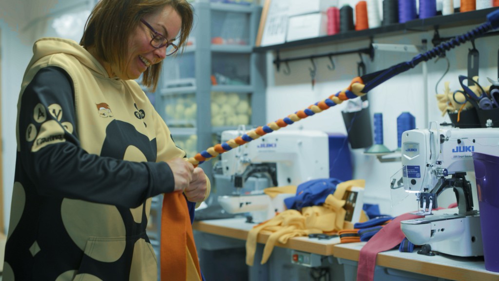 Paula hand braids the fabric of one of the Paws Made training toys for Paws Trading