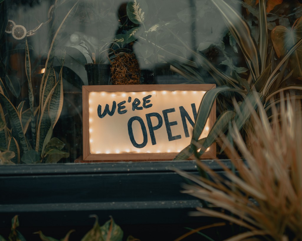 a sign in a window reading we're open