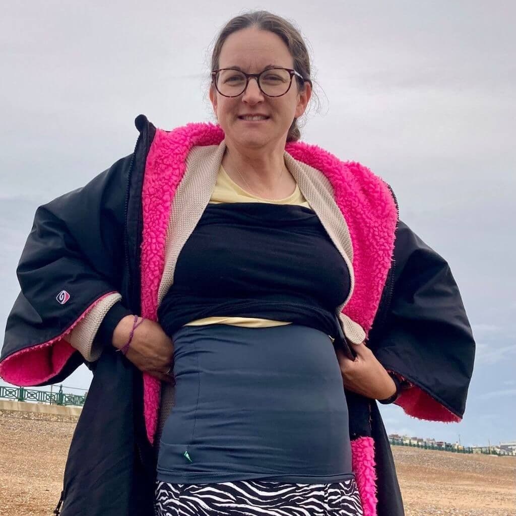 A woman shows off her haramaki, a body warmer that supports small business and makes a great Christmas gift