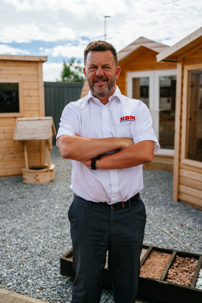 Jeff Smith of Keith Builders Merchant stands in from of garden sheds at their warehouse in Aberdeen