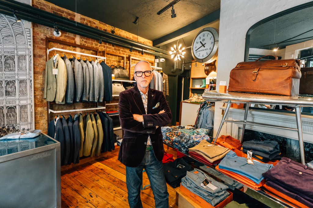 Simon Carter stands inside his shop