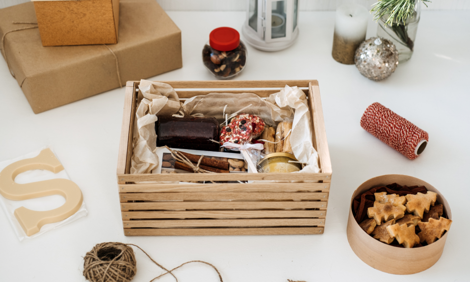 a wooden crate sits on a desk filled with goodies for selling subscription boxes online